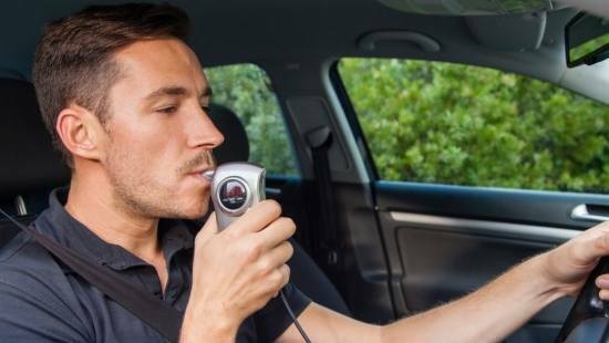 man using breathalyzer